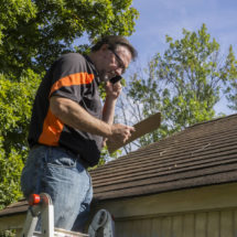 Roof Contractor Inspecting Roof After Hail Damage